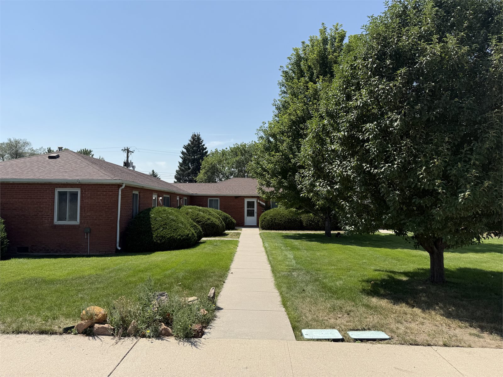 Landscaped walkway and brick exterior at 1311 E. Caramillo